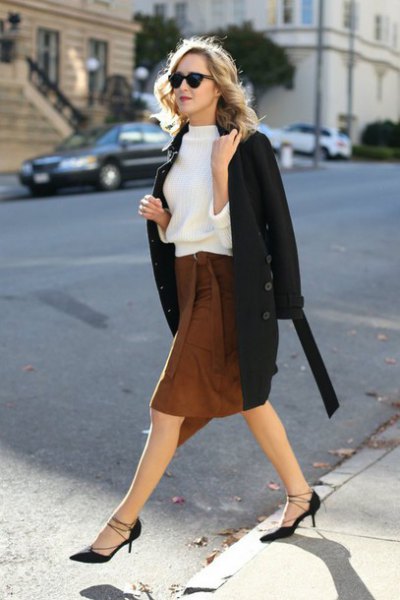 white sweatshirt with black wool coat and brown knee-length skirt