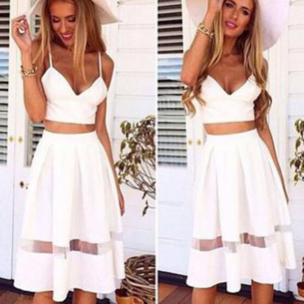 white, figure-hugging crop top with a high, flared midi skirt