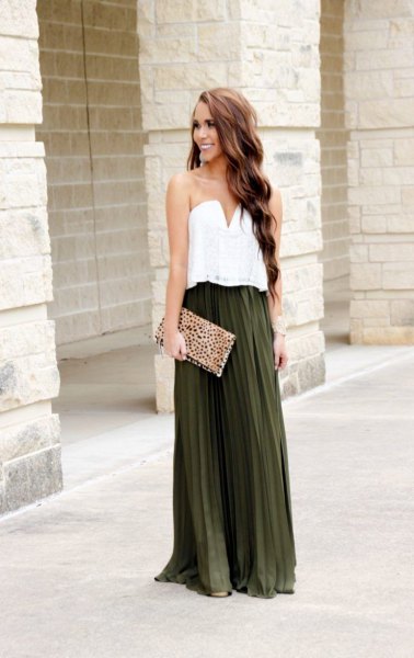 white blouse with sweetheart neckline and dark green pleated skirt