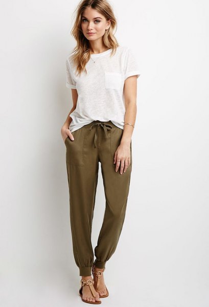 white t-shirt with olive green joggers and sandals