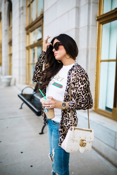 white t-shirt with a leopard print jacket and ripped blue jeans
