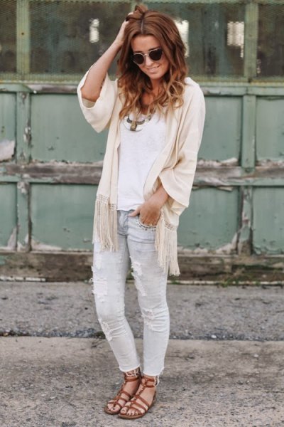 white top with ivory cape with half sleeves and light gray jeans
