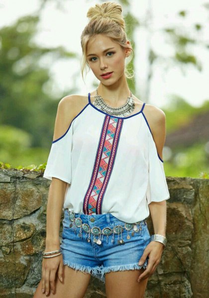 white blouse with tribal print and light blue mini denim shorts
