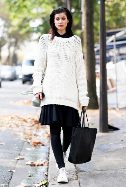 white tunic sweater with black minirater skirt