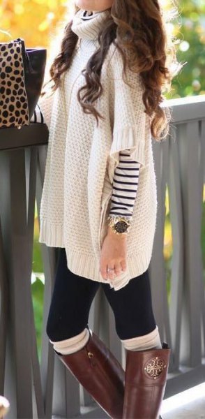 Chunky poncho sweater with white turtleneck and sleeves over the striped long-sleeved T-shirt