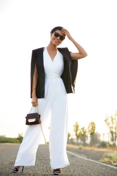 white jumpsuit with V-neck and flare with black blazer