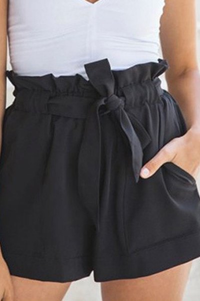 white, sleeveless blouse with V-neck and black mini-shorts