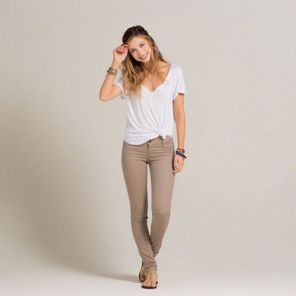 white knotted V-neck t-shirt and gray-green super skinny jeans