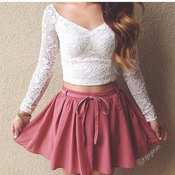 long-sleeved white lace crop top with a v-neckline and pink skater skirt
