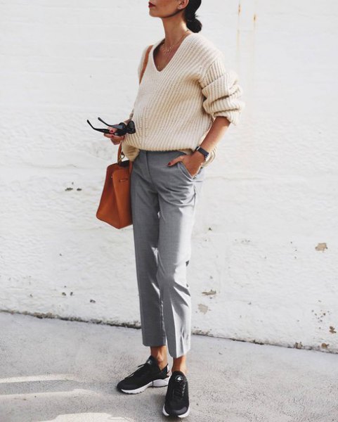 white ribbed sweater with V-neckline and gray, short-cut chinos