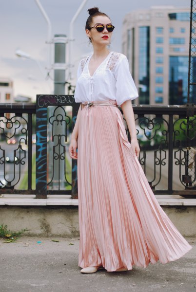 white short-sleeved blouse with V-neckline and light pink, flowing skirt