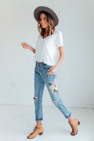 white T-shirt with V-neckline and floral embroidered cropped jeans