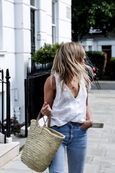white tank top with V-neck, blue jeans and straw sack