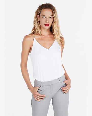 white tank top with V-neck and gray slim fit jeans