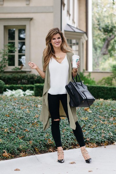 white V-neck tank top, olive-green longline vest and ripped jeans