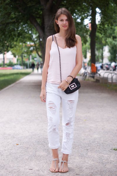 white V-neck tank top with ripped boyfriend jeans and flat sandals