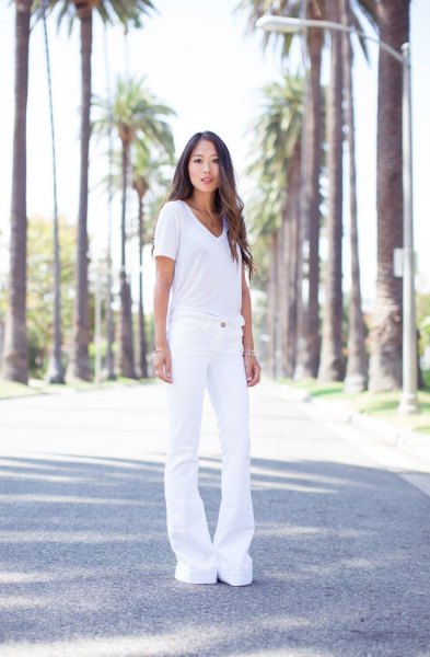 white V-neck t-shirt and white jeans with a bell bottom
