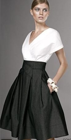white wrap blouse with V-neckline and black, high-waisted midi skirt with pockets