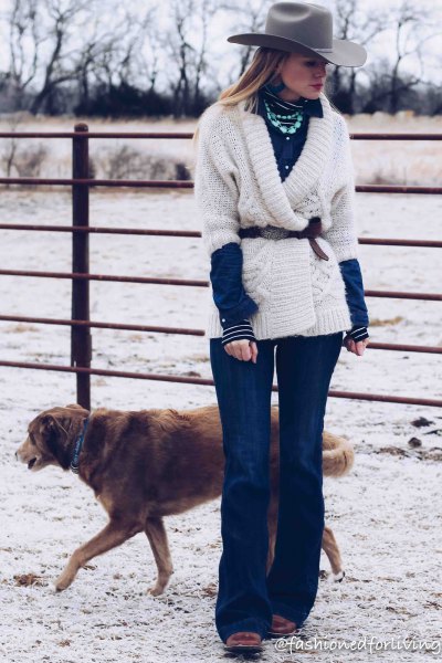 white wrap sweater with belt, blue flared jeans and black square toe boots