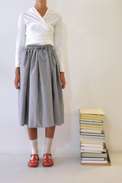 gray pleated mini skirt with white wrap jacket