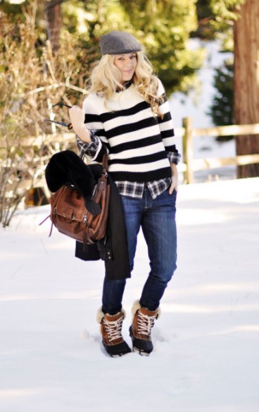 wide striped sweater with jeans and brown and black snowshoes