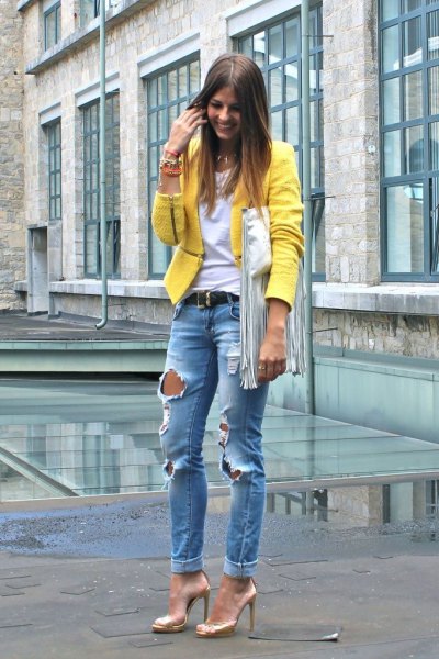 yellow blazer with blue ripped boyfriend jeans with gold evening shoes