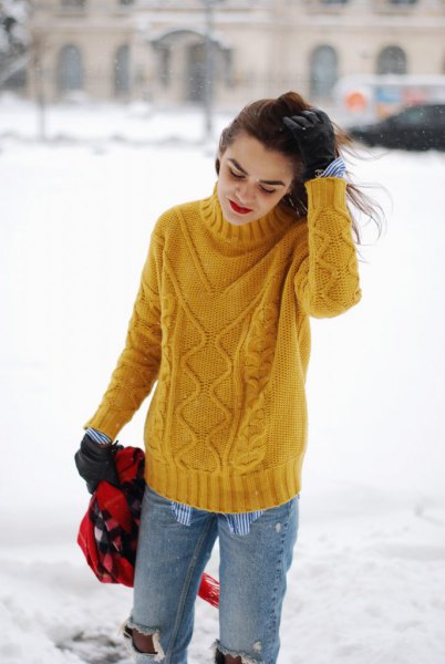 yellow cable knit sweater with torn boyfriend jeans