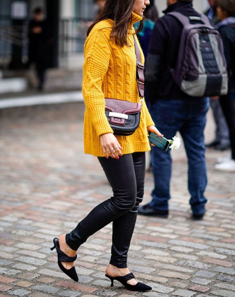 yellow cable knit sweater with black thin leather pants