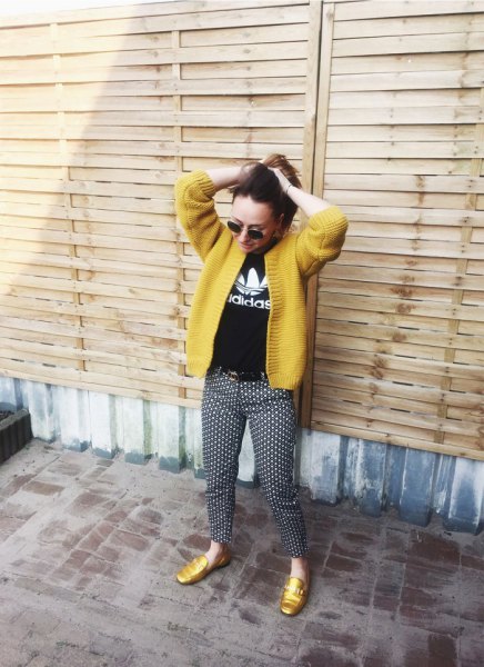 yellow cardigan with black printed T-shirt and dotted trousers