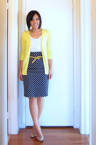 yellow cardigan with white vest and dotted midi skirt