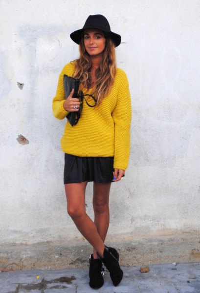 yellow, chunky sweater with mini skirt and black felt hat