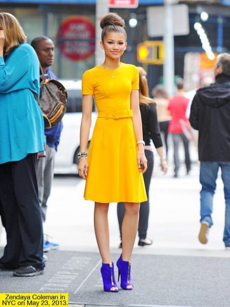 Knee-length dress with a yellow fit and flare with royal blue ankle boots with open toes