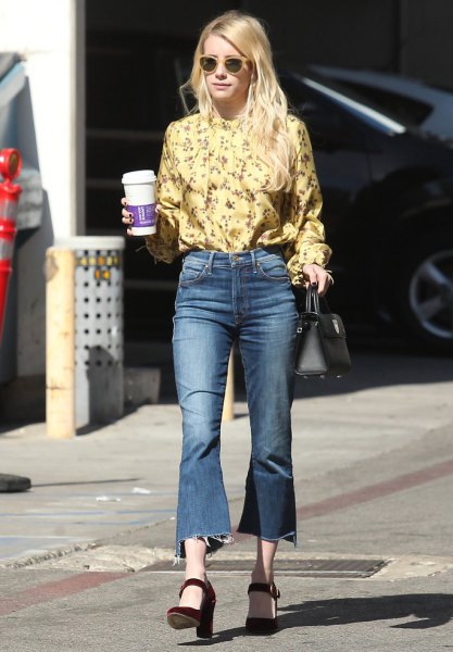 yellow blouse with a floral pattern and flared, cropped jeans