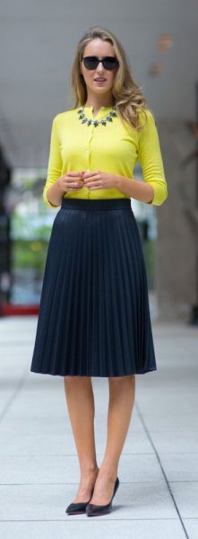 yellow half sleeve without collar blouse with pleated midi navy skirt