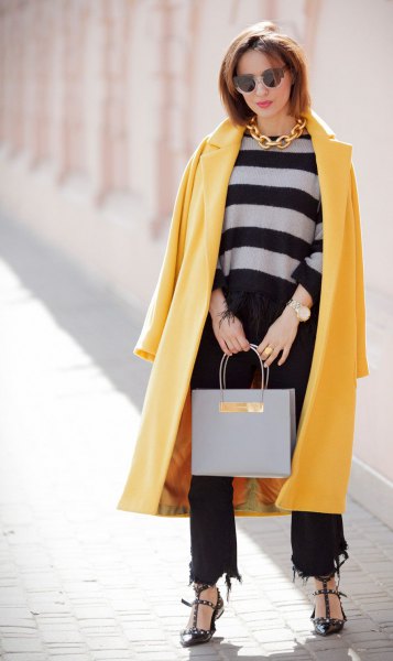 yellow maxi wool coat with black, cropped and ripped jeans