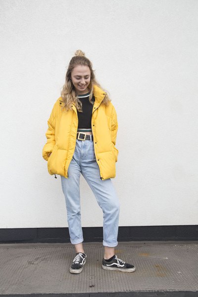 yellow puffer jacket with black, short sweater and mom jeans