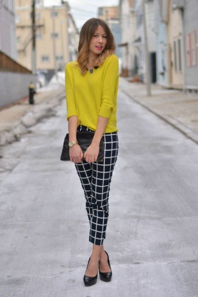 yellow sweater with black and white, narrow checked trousers