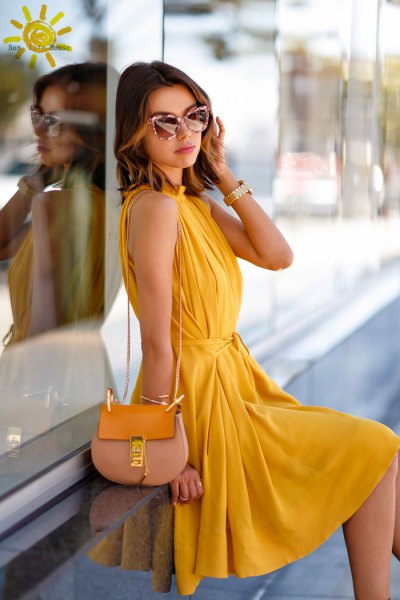 yellow sleeveless, pleated midi pleated dress with pink wallet