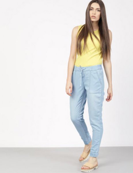 yellow sleeveless top with blue high-waisted jogger pants